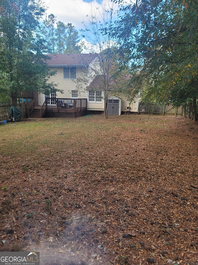 view of yard with a shed and a deck