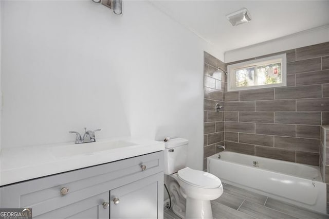 full bathroom with hardwood / wood-style flooring, vanity, toilet, and tiled shower / bath combo