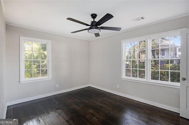 unfurnished room featuring ceiling fan, plenty of natural light, dark hardwood / wood-style floors, and ornamental molding