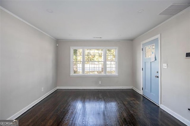 spare room with ornamental molding and dark wood-type flooring