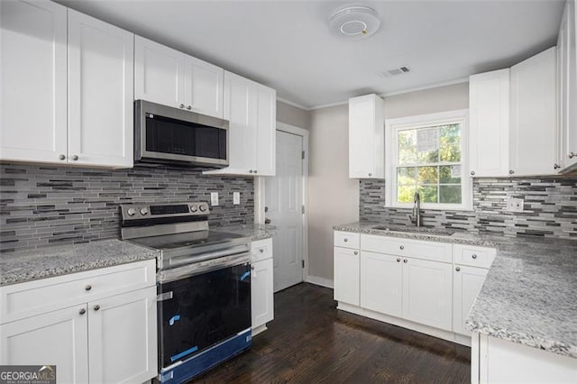 kitchen with sink, white cabinetry, stainless steel appliances, and dark wood-type flooring