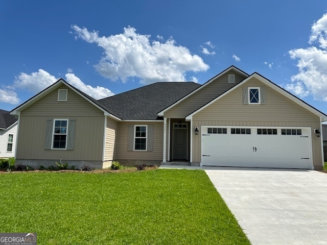 view of front of house with a front lawn and a garage