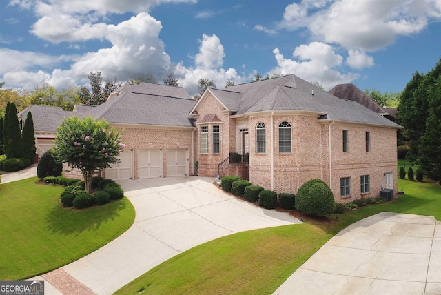 view of front of house with cooling unit, a garage, and a front lawn