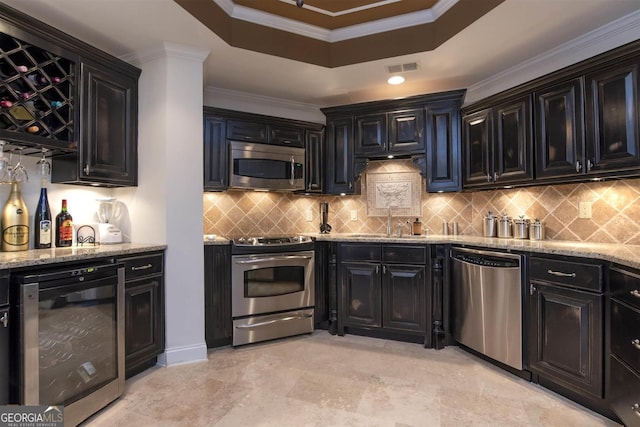 kitchen featuring sink, ornamental molding, stainless steel appliances, and wine cooler