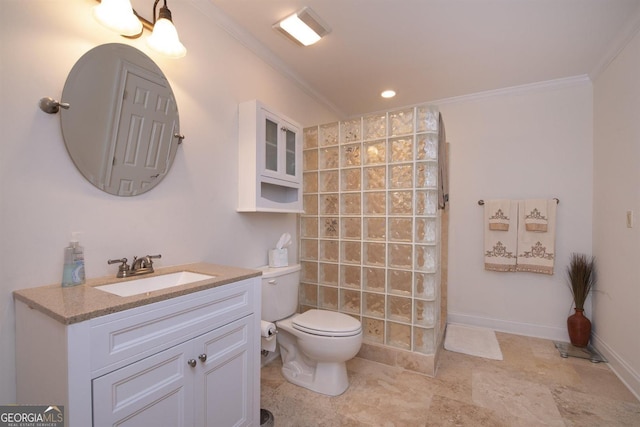 bathroom with toilet, vanity, and ornamental molding