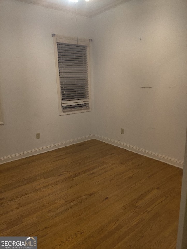 spare room featuring dark hardwood / wood-style floors