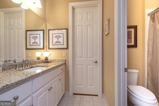 bathroom featuring tile patterned flooring, vanity, and toilet