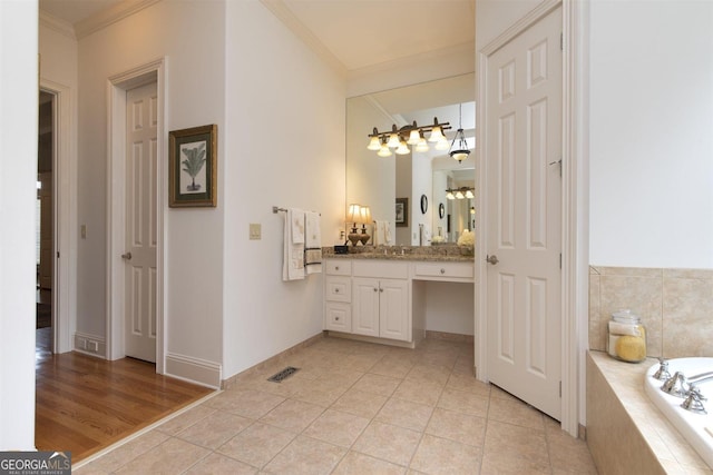 bathroom featuring vanity, tile patterned floors, and ornamental molding