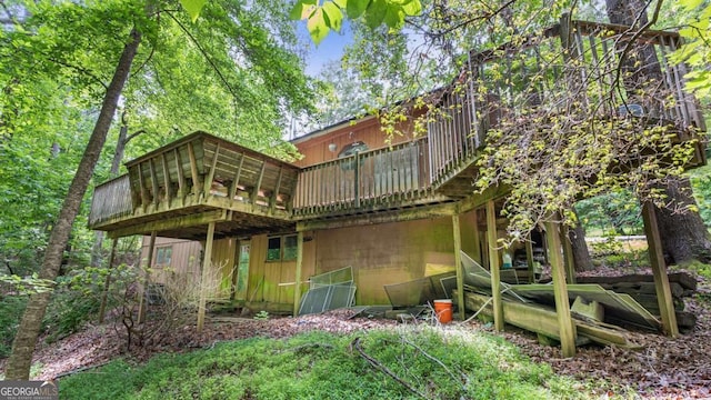 back of house with a wooden deck