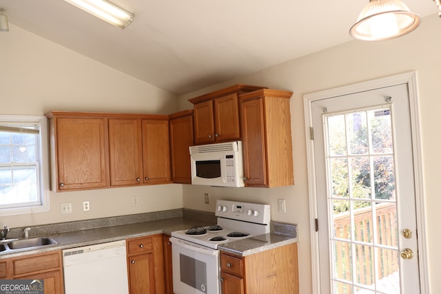 kitchen featuring lofted ceiling, sink, and white appliances