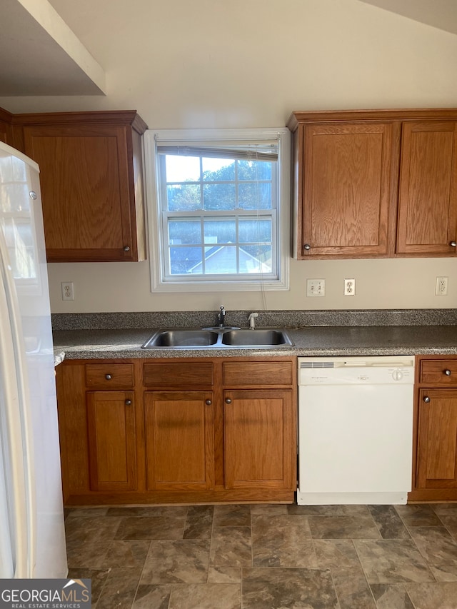 kitchen with lofted ceiling, sink, and white appliances