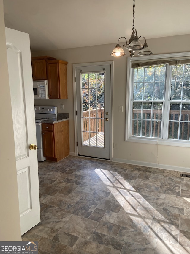 kitchen featuring an inviting chandelier, hanging light fixtures, and electric range oven