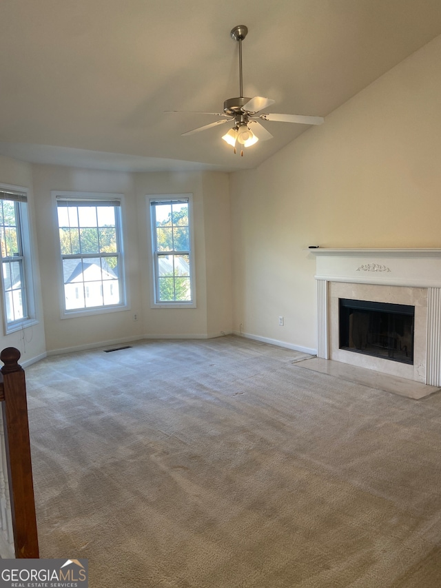 unfurnished living room with light carpet, lofted ceiling, and ceiling fan