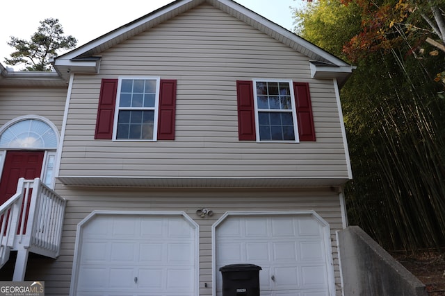 view of side of home featuring a garage