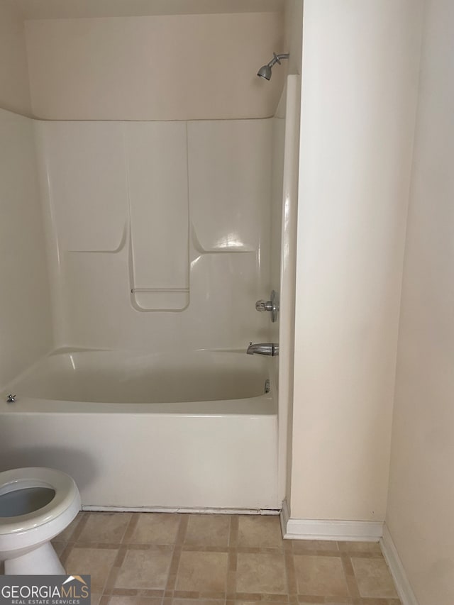 bathroom featuring washtub / shower combination and toilet