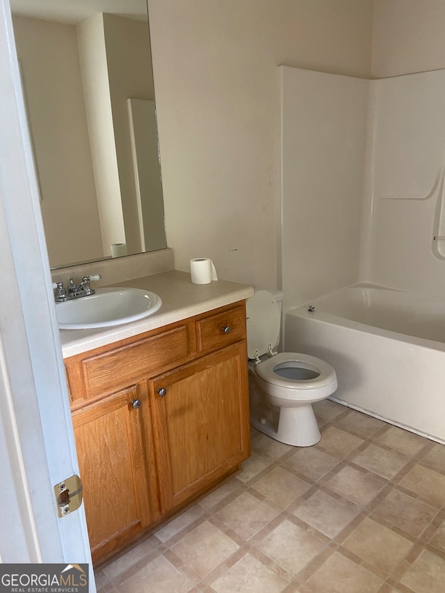 full bathroom featuring toilet, vanity,  shower combination, and tile patterned flooring