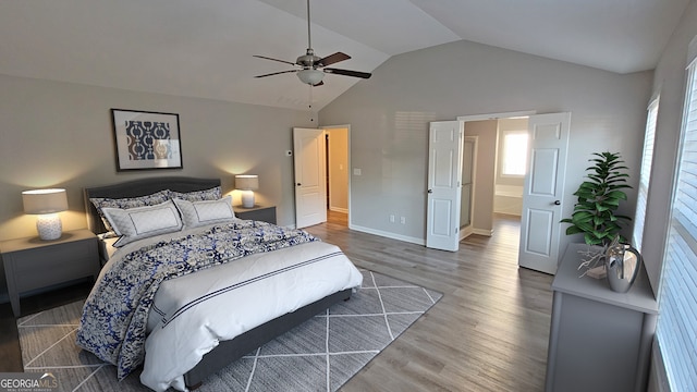 bedroom featuring dark hardwood / wood-style flooring, ceiling fan, and lofted ceiling