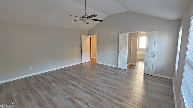 unfurnished bedroom with light wood-type flooring, vaulted ceiling, and ceiling fan