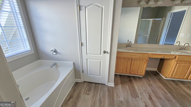 bathroom with shower with separate bathtub, vanity, and hardwood / wood-style flooring