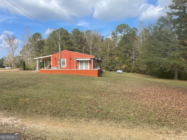 view of side of property with a yard