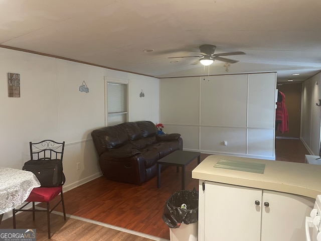 living room with dark wood-type flooring and ceiling fan