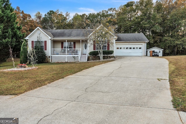 view of front of property with a garage, a front lawn, and a porch