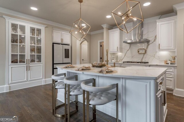 kitchen with white cabinets, a kitchen island with sink, and dark hardwood / wood-style flooring