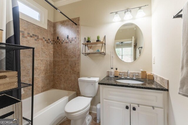 full bathroom with vanity, toilet, tiled shower / bath combo, and a wealth of natural light