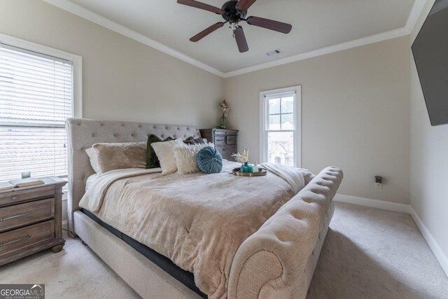 bedroom with crown molding, light colored carpet, and ceiling fan