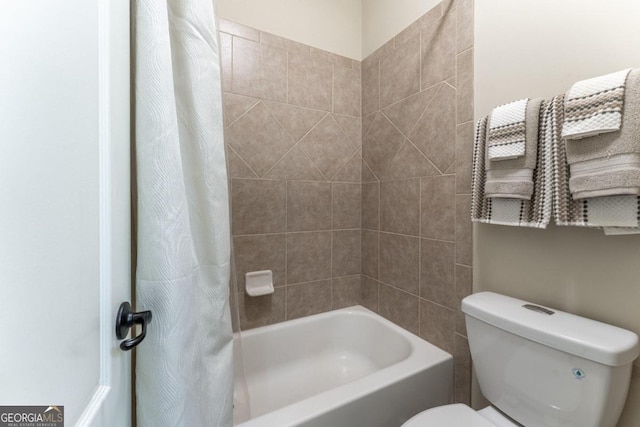 bathroom featuring toilet and shower / tub combo with curtain