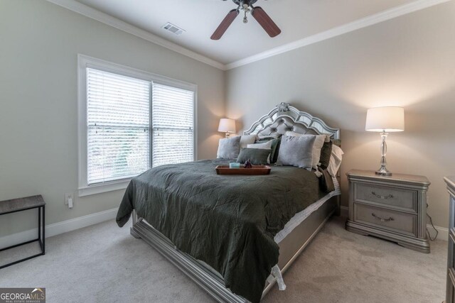 bedroom with crown molding, light carpet, and ceiling fan