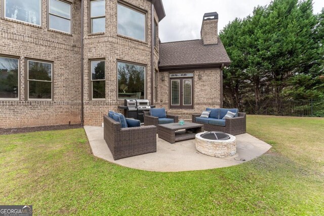 view of patio featuring an outdoor living space with a fire pit