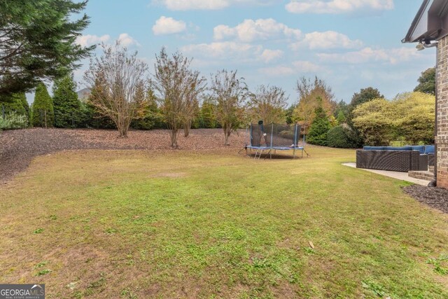 view of yard with a trampoline