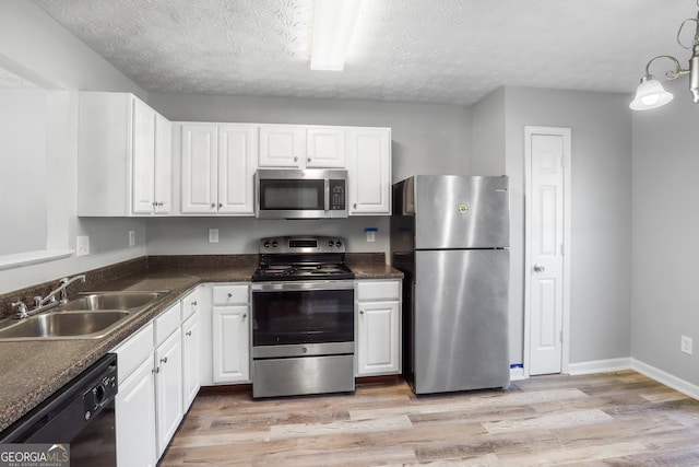 kitchen with light hardwood / wood-style flooring, white cabinets, sink, and stainless steel appliances