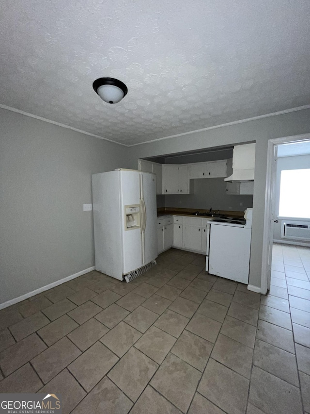 121-123 E King Ave, Kingsland, GA 31548 - kitchen with white appliances, a textured ceiling, white cabinets, premium range hood, and light tile patterned flooring