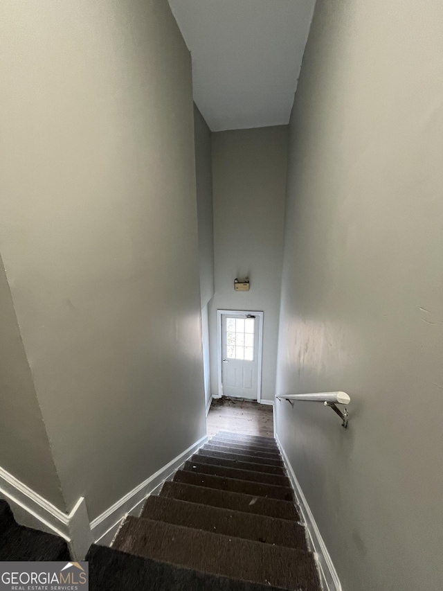121-123 E King Ave, Kingsland, GA 31548 - stairs featuring baseboards and a high ceiling