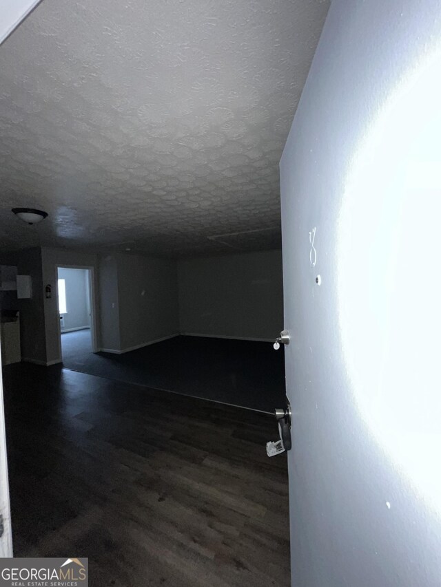 121-123 E King Ave, Kingsland, GA 31548 - corridor with a textured ceiling and wood finished floors