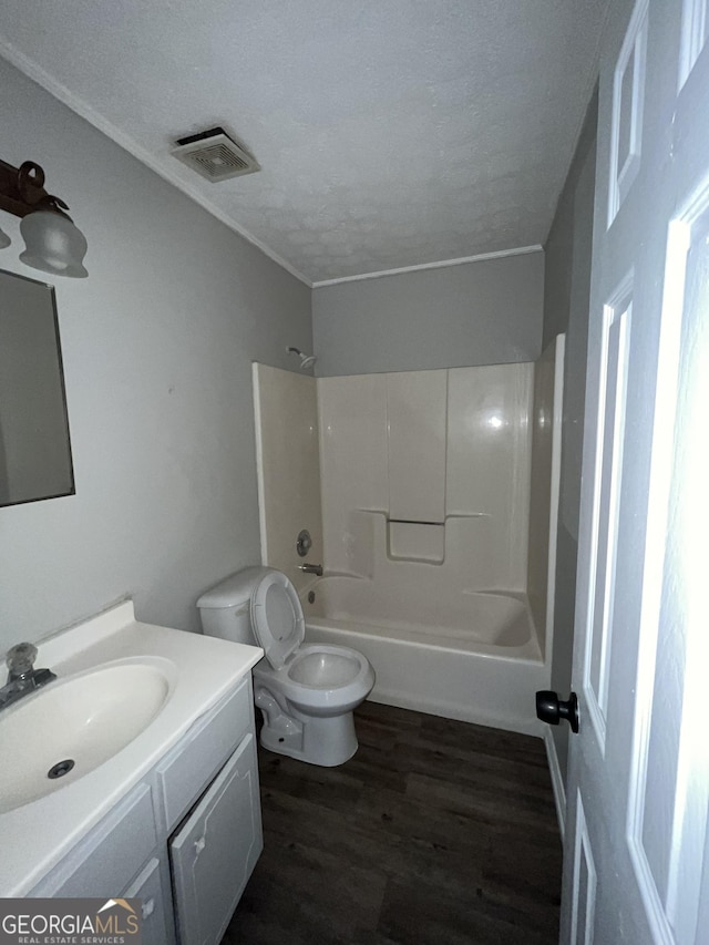 121-123 E King Ave, Kingsland, GA 31548 - full bathroom featuring vanity, toilet, a textured ceiling, shower / bath combination, and wood finished floors