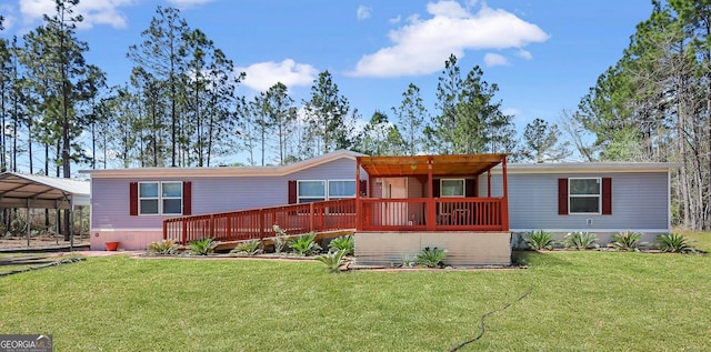 30 David Rd, Hinesville, GA 31313 - manufactured / mobile home featuring a front yard, a wooden deck, and a carport