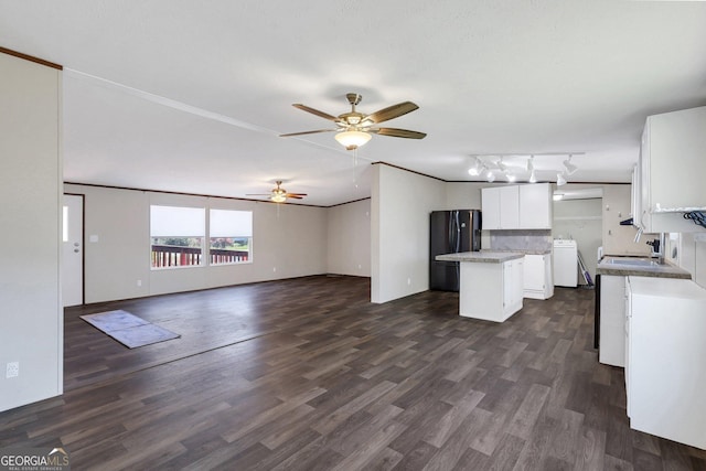 30 David Rd, Hinesville, GA 31313 - kitchen featuring a center island, freestanding refrigerator, white cabinetry, ceiling fan, and washer / clothes dryer