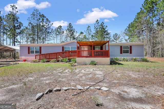 30 David Rd, Hinesville, GA 31313 - manufactured / mobile home featuring a wooden deck and a carport