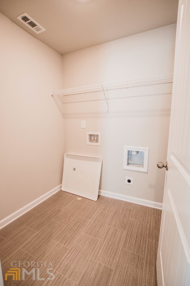 washroom featuring hookup for an electric dryer, washer hookup, and wood-type flooring