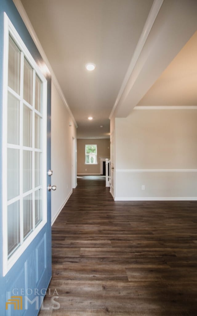 hall featuring ornamental molding and dark hardwood / wood-style floors