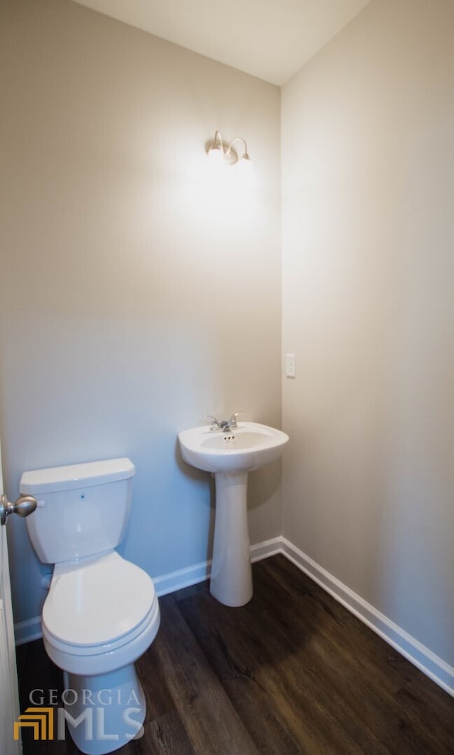 bathroom featuring toilet and hardwood / wood-style flooring