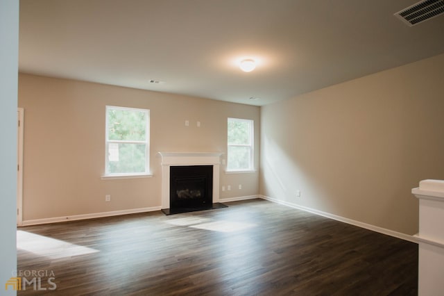 unfurnished living room with dark hardwood / wood-style floors