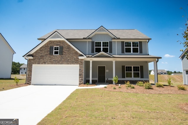 craftsman-style house featuring a front yard, a porch, and a garage