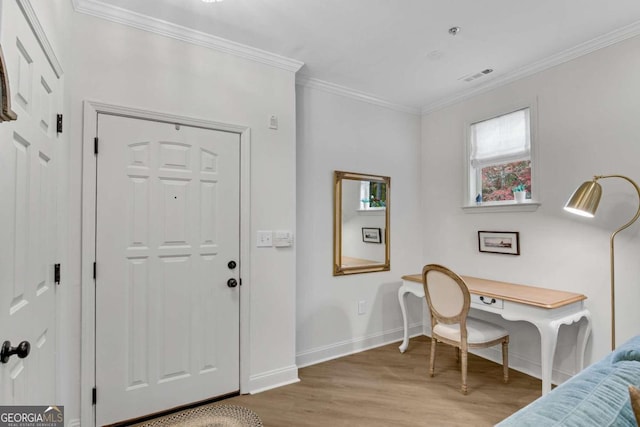 entryway with light wood-type flooring and crown molding