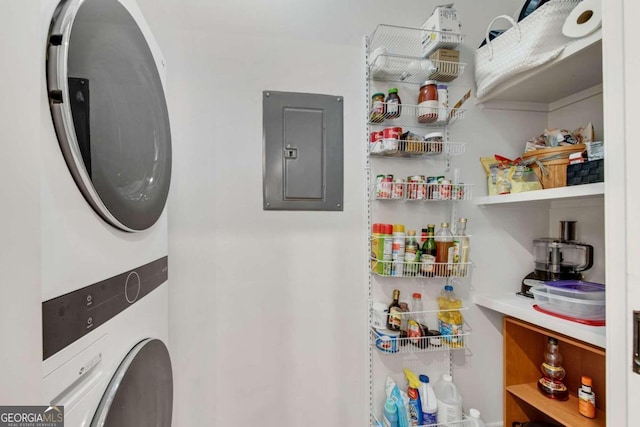 interior space with stacked washing maching and dryer and electric panel