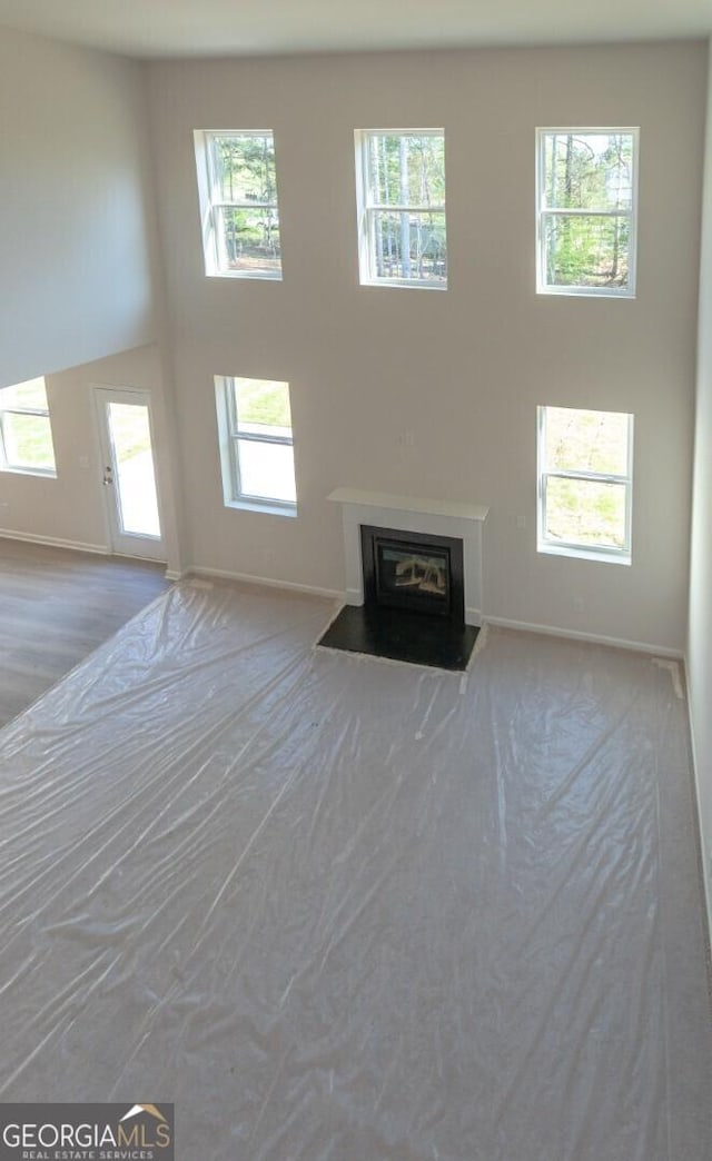 470 River Run Dr Unit 63, Dallas, GA 30132 - unfurnished living room with plenty of natural light, a fireplace with flush hearth, and baseboards