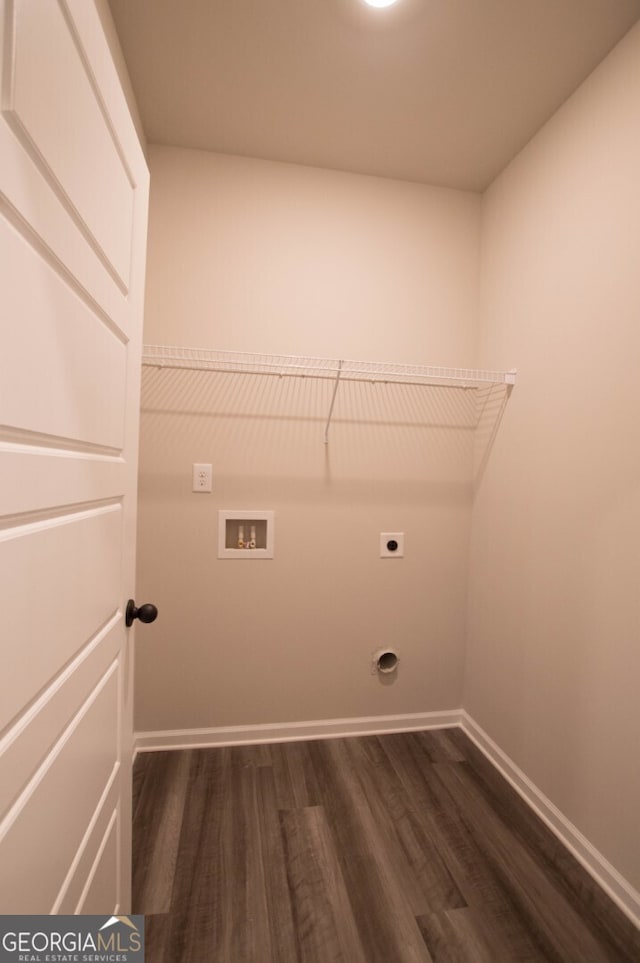 washroom with hookup for an electric dryer, dark wood-type flooring, and hookup for a washing machine